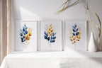Gold and navy blue botanical watercolor wall art – elegant golden foliage on deep blue background